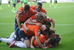Jack Marriott is buried under happy team mates after scoring Town`s second goal