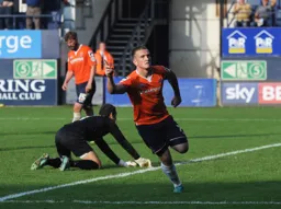 Jack Marriott wheels away after scoring his and Town`s second goal. Leaving future Hatter James Shea on his hands and knees