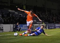 Alex Lawless skips past a sliding tackle