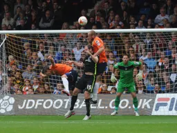 Scott Cuthbert heads clear under pressure from Keith Lowe