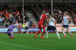 Cameron McGeehan sees his attempt at goal saved by Darryl Flahaven