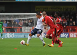 Nathan Doyle is closed town by two Crawley players
