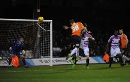 Luke Wilkinson powers a header towards goal