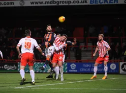 Josh McQuoid gets above Ronnie Henry to send a header towards goal