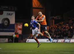 Scott Cuthbert heads the ball away from Charlie Wyke