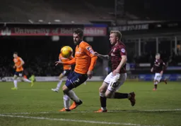 Alex Lawless keeps the ball away from Nicky Adams