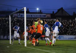 Steve Mildenhall catches the ball under pressure from Scott Cuthbert