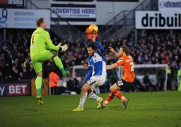 Steve Mildenhall comes to claim the ball from an on rushing Craig Mackail-Smith