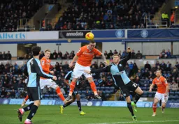 A spring heeled Jack Marriott rises to send a header towards goal