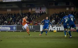 Jake Howells tries a shot from the edge of the penalty area