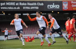 Olly Lee celebrates his last minute winner with Craig Mackail-Smith and Jack Marriott