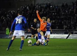 Cameron McGeehan is stopped in his tracks by a strong challenge
