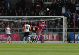Elliot Justham fists the ball away from danger