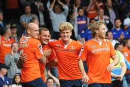 Scott Cuthbert, Cameron McGeehan and Craig Mackail-Smith join Luke Wilkinson to celebrate his goal