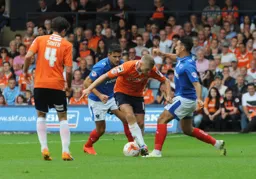 Scott Griffiths gets between two opponents and comes away with the ball