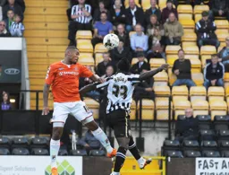 Ryan Hall gets above Stanley Aborah to head the ball forward