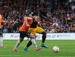 Scott Griffiths finds himself in a headlock as he challenges for the ball