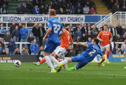 Jonathan Smith gets inbetween defenders to open the scoring