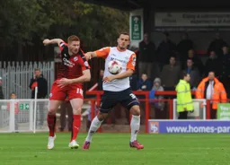 Jack Marriott and Matt Harrold compete for the ball