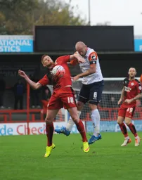 Scott Cuthbert heads the ball away from Matt Harrold