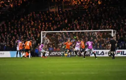 Scott Cuthbert blocks a shot from future Hatter Luke Gambin