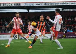 Paul Benson gets between former Hatters Fraser Franks and Ronnie Henry