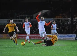 Josh McQuoid knocks the ball past Alex Rodman
