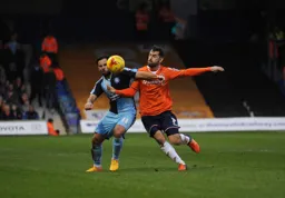 Alex Lawless is held off the ball by Sam Wood