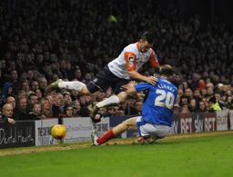 Jack Marriott feels the full force of Matt Clarke`s tackle