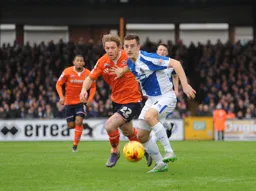 Craig Mackail-Smith is held off the ball by future Hatter Tom Lockyer