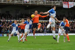 Paul Benson gets above Tom Lockyer to win a header