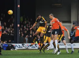 Paul Benson sends a header towards goal