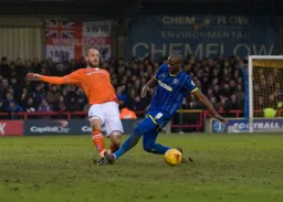 Scott Cuthbert clears the ball before Tom Elliott can intervene