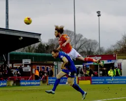 Craig Mackhail-Smith goes in with a diving header