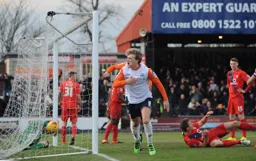 Cameron McGeehan celebrates his goal towards the travelling Hatters fans