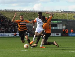 Pelly-Ruddock Mpanzu works his way between two defenders