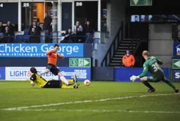A sliding tackle stops Jack Marriott