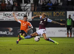 Jack Marriott`s shot just eludes the outstretched leg of Jordan Amavi