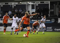Cameron McGeehan scores his and the Town`s first penalty of the evening