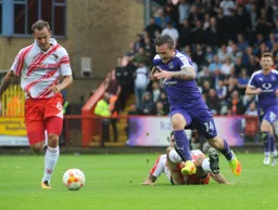 Jack Marriott rides one tackle but has former Hatter Luke Wilkinson in hot pursuit