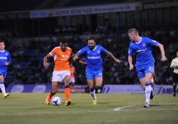 Isaac Vassell takes on two opposition players