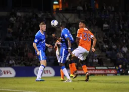 Akin Famewo heads the ball forward