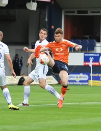Jordan Cook stretching to keep the ball under control