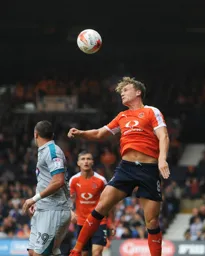 Cameron McGeehan heads the ball