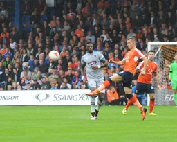Dan Potts volleys the ball clear