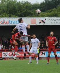 Stephen O`Donnell heads the ball clear as future Hatter James Collins looks on