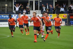 Cameron McGeehan leads the celebrations after scoring his second and Town`s third goal