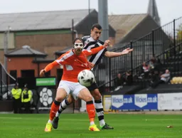 Danny Hylton battles for the ball