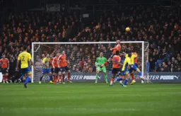 Scott Cuthbert heads the ball away from danger