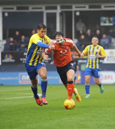 Danny Hylton takes on Accrington's Sean McConville